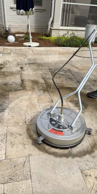 Cody-X cleans outdoor stone tiles with a pressure washer, removing grime. Cody-X Pressure Washing