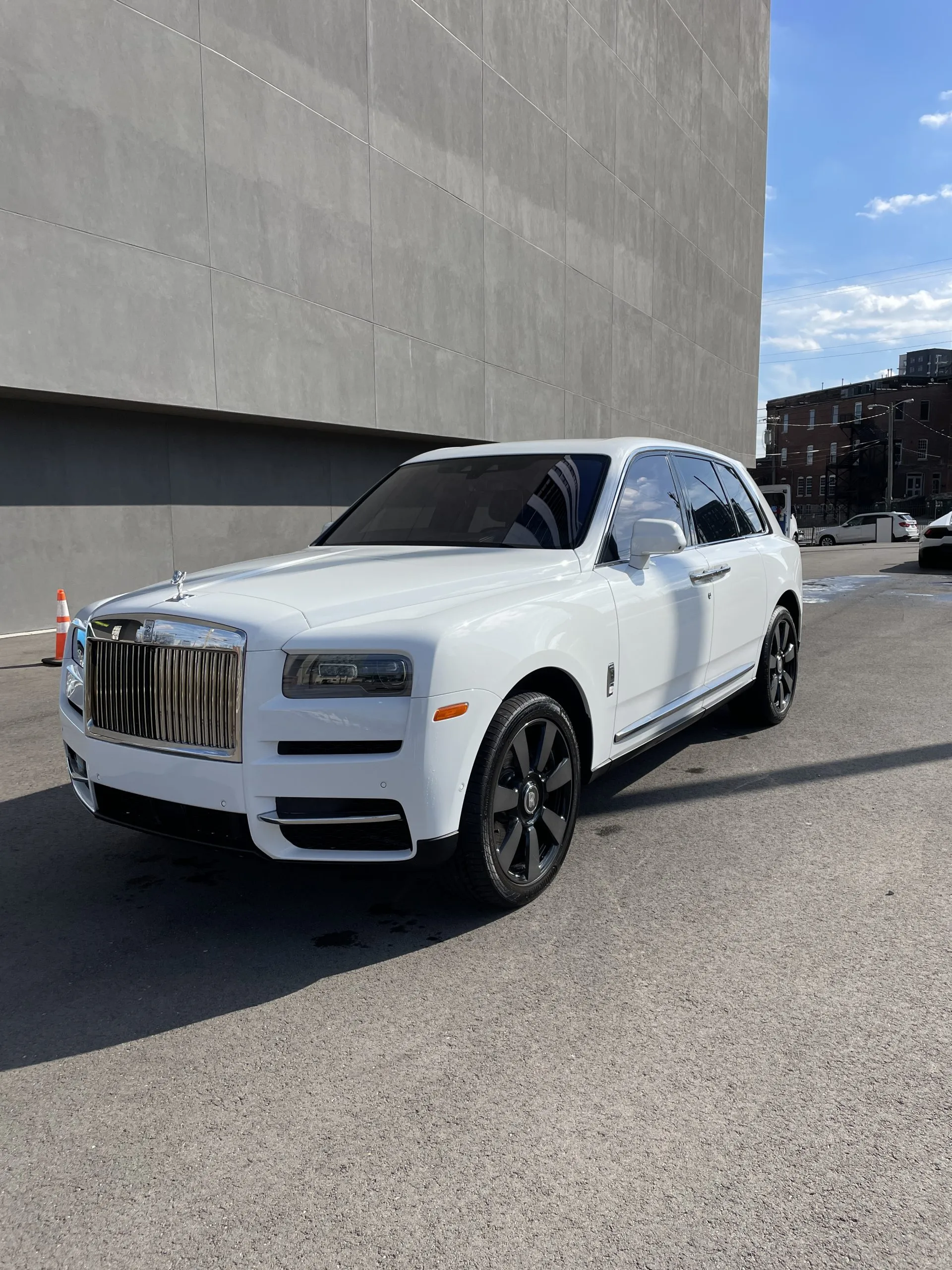 IMG_4544-scaled White Rolls Royce SUV parked by a concrete building under sunny skies Cody X Pressure Washing