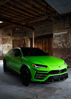 Photo Dec 18 2024, 9 16 01 AM (1) Green Lamborghini SUV parked in a partly renovated industrial building. Cody-X Pressure Washing