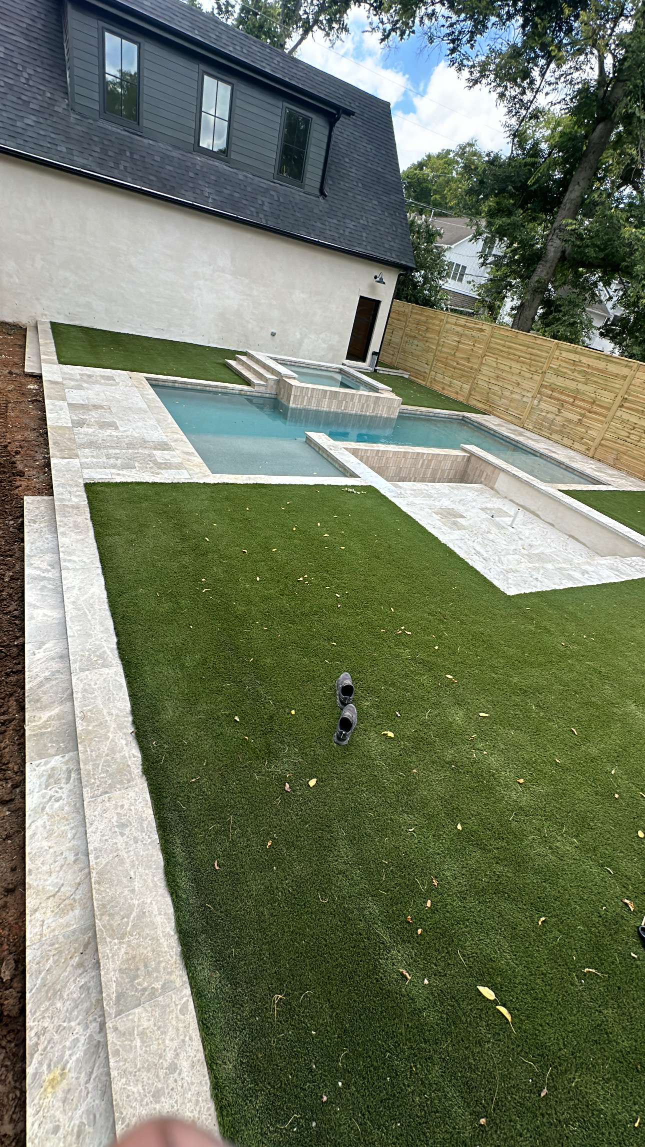 317DFBE6-FEED-4861-BC5B-493C61B3DEC4 Backyard with artificial grass, small pool, stone edging, shoes on lawn Cody X Pressure Washing