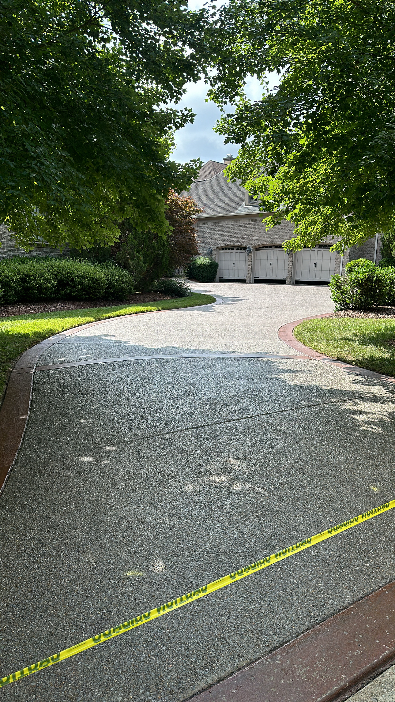 5ED55614-21CF-46B8-BAB7-C17D0077338B Freshly poured driveway blocked by caution tape; large home in back Cody X Pressure Washing