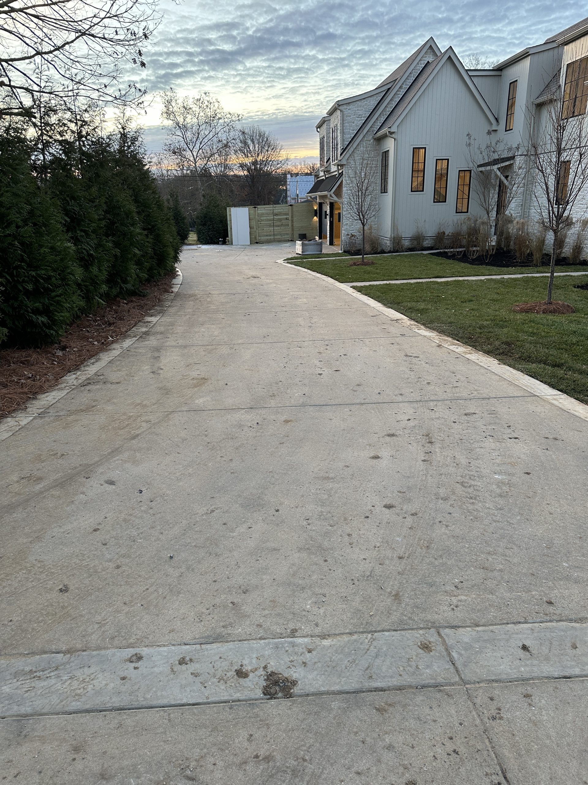 IMG_1982 Concrete driveway to a two story house with neat lawn and trees; Cody X service Cody X Pressure Washing
