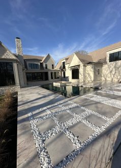 IMG_2007 2 Modern beige stone home with large windows, pool, and stone walkway. Cody-X Pressure Washing