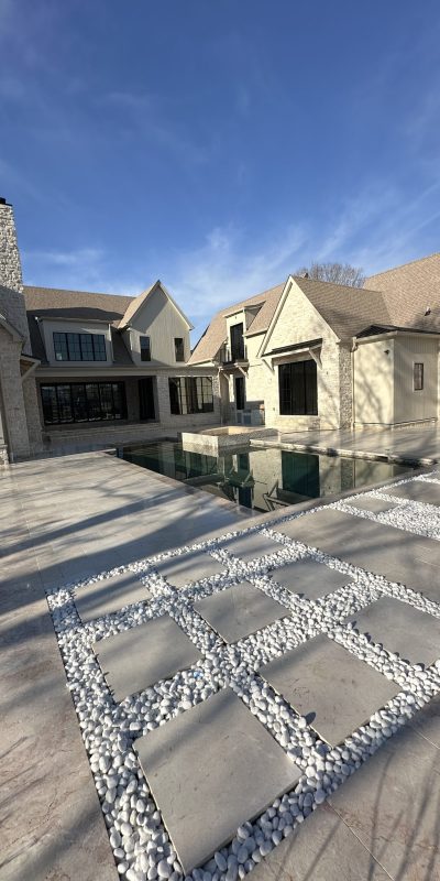 IMG_2007 2 Modern beige stone home with large windows, pool, and stone walkway. Cody-X Pressure Washing