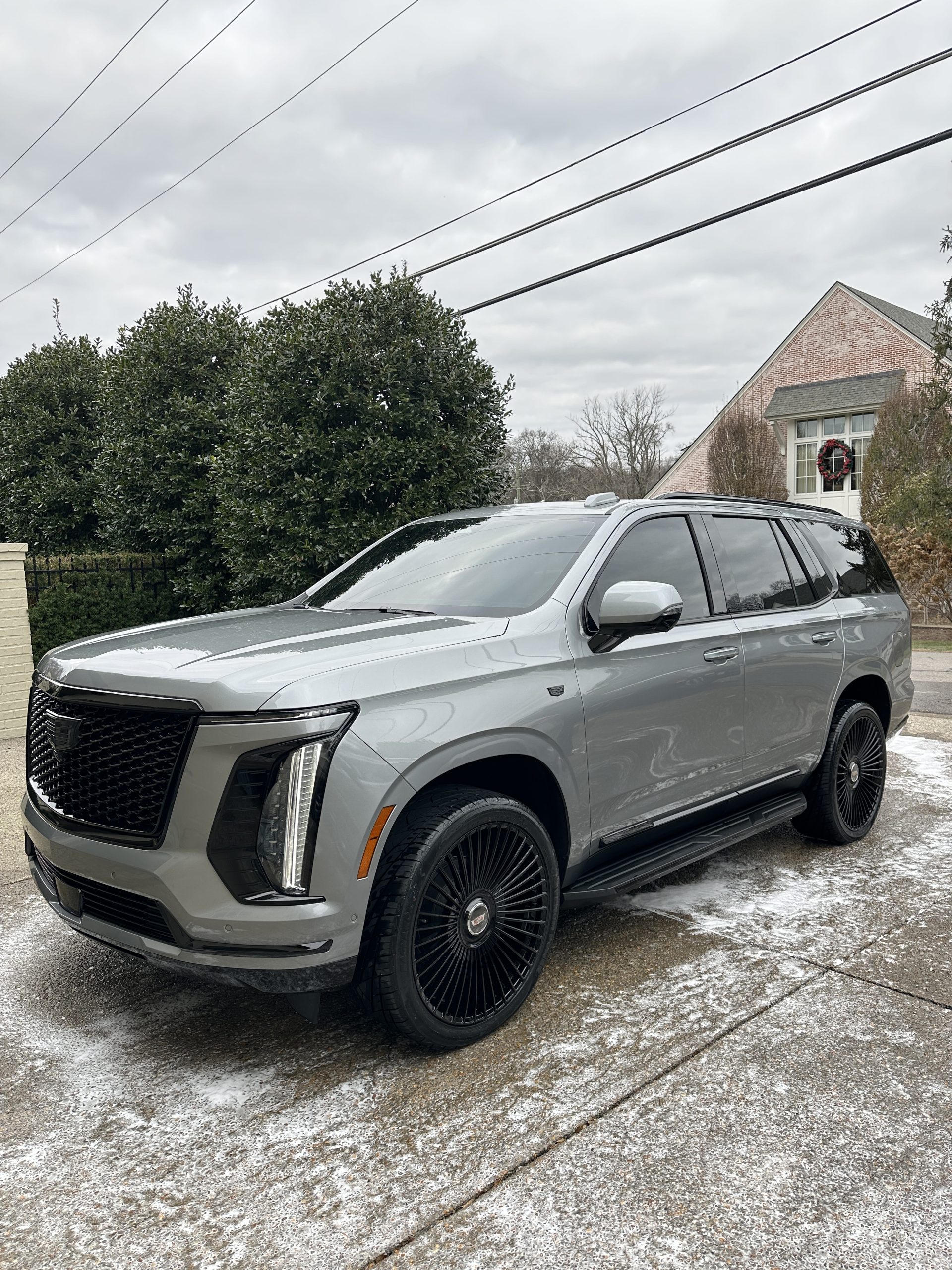 IMG_2033 A silver Cadillac Escalade on a snowy driveway at Cody X's pressure washing business Cody X Pressure Washing