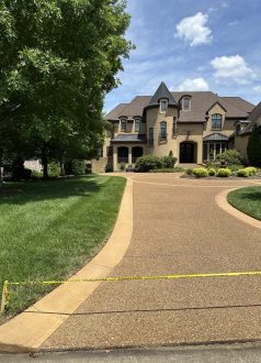 IMG_9120 Large brick house, manicured lawn, blocked driveway with caution tape. Cody-X Pressure Washing